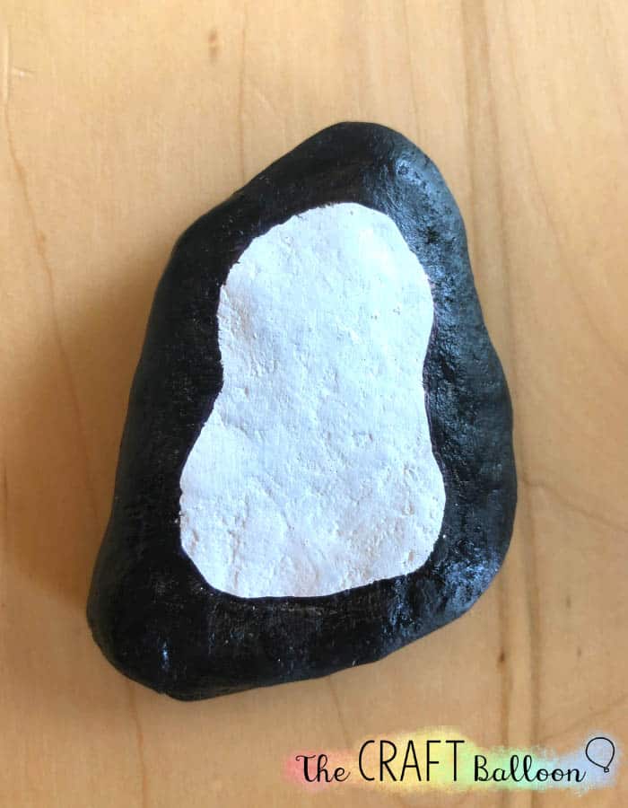 black painted rock with white centre