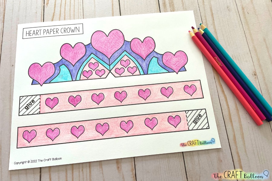 Printed heart paper crown template, coloured in using colouring pencils.