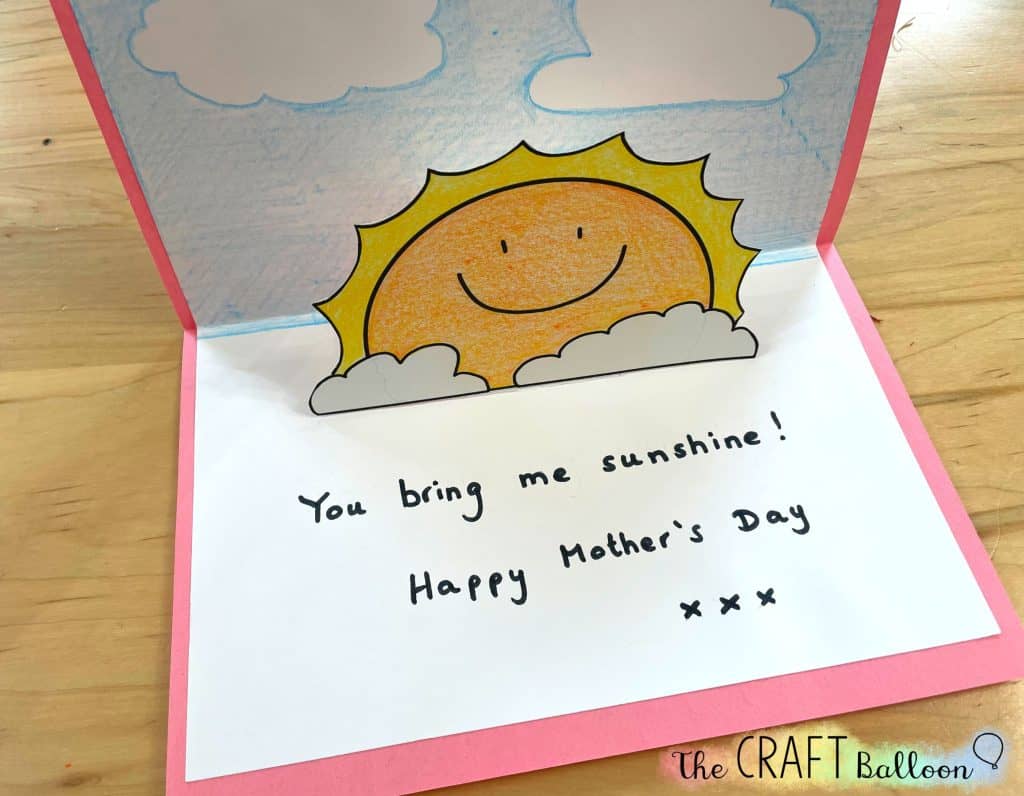 Completed sunshine pop up mother's day card with "you bring me sunshine" message written on