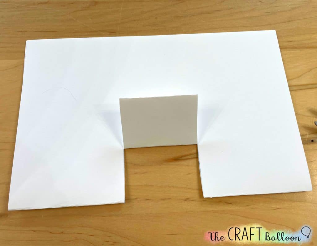 letter sized paper with two cuts and tab folded upwards