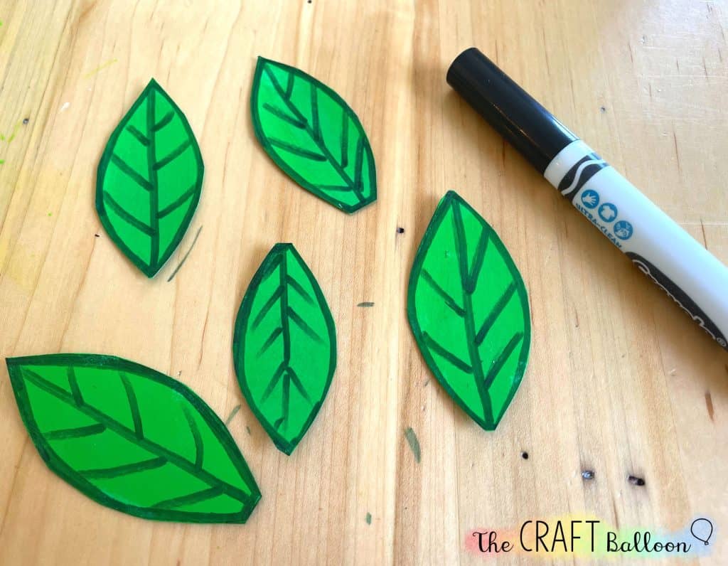 five leaves from green card stock with black out line and details drawn on